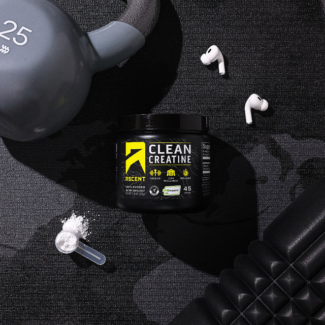 ascent clean creatine on ground next to workout equipment