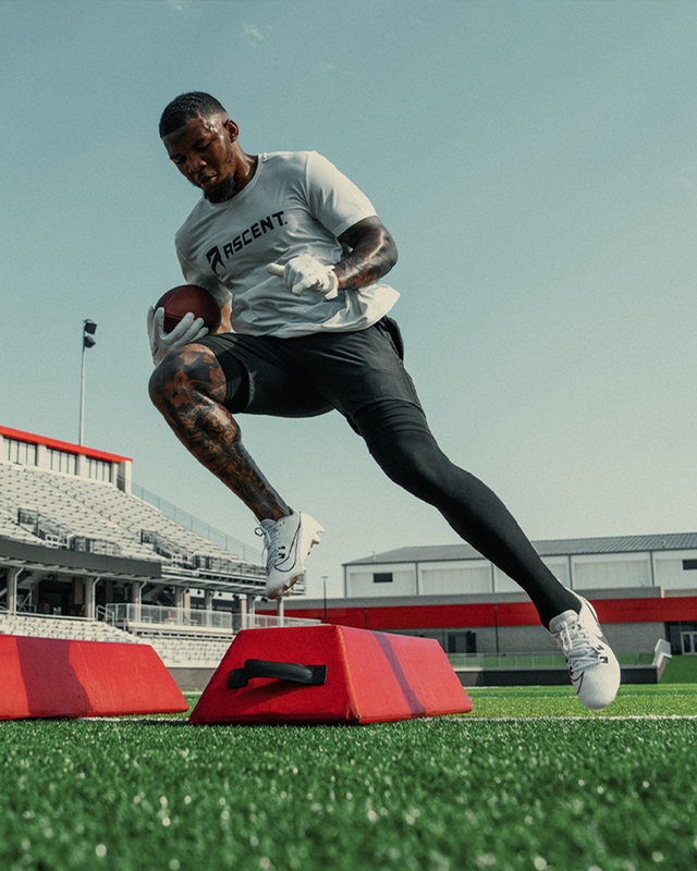 split_row_banner_2 ascent protein athlete running football drills while holding a football